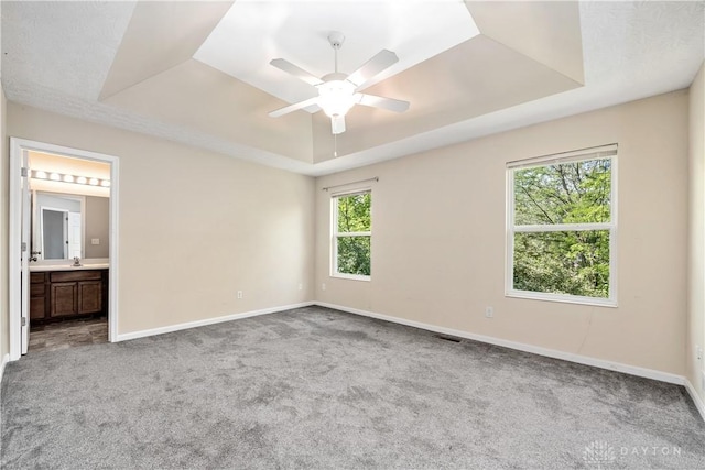 5065 Cross Creek Ln, Miami Township, OH 45150 - carpeted spare room featuring a tray ceiling, baseboards, and ceiling fan
