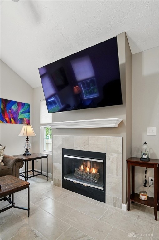 detailed view of a tiled fireplace and baseboards