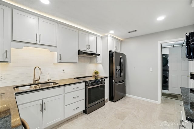 kitchen featuring black fridge with ice dispenser, stainless steel range with electric stovetop, a sink, stacked washer / dryer, and under cabinet range hood