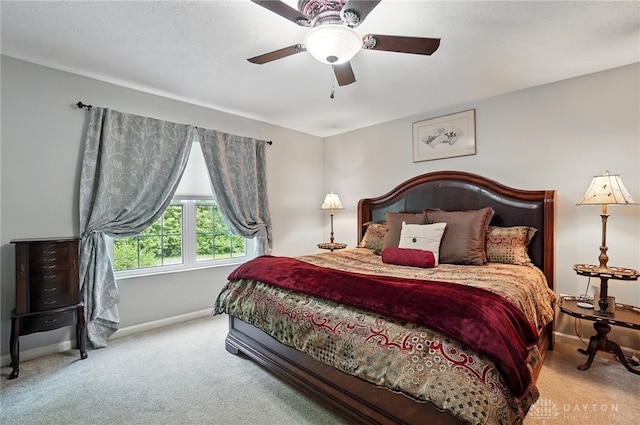 bedroom featuring carpet floors, baseboards, and a ceiling fan