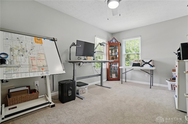 office space featuring carpet flooring, baseboards, and a ceiling fan