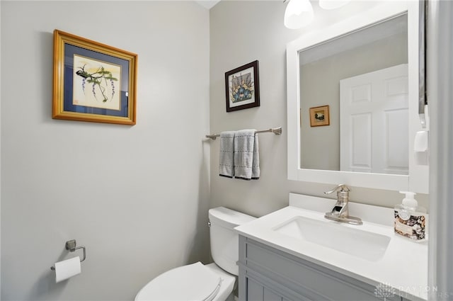 bathroom featuring toilet and vanity