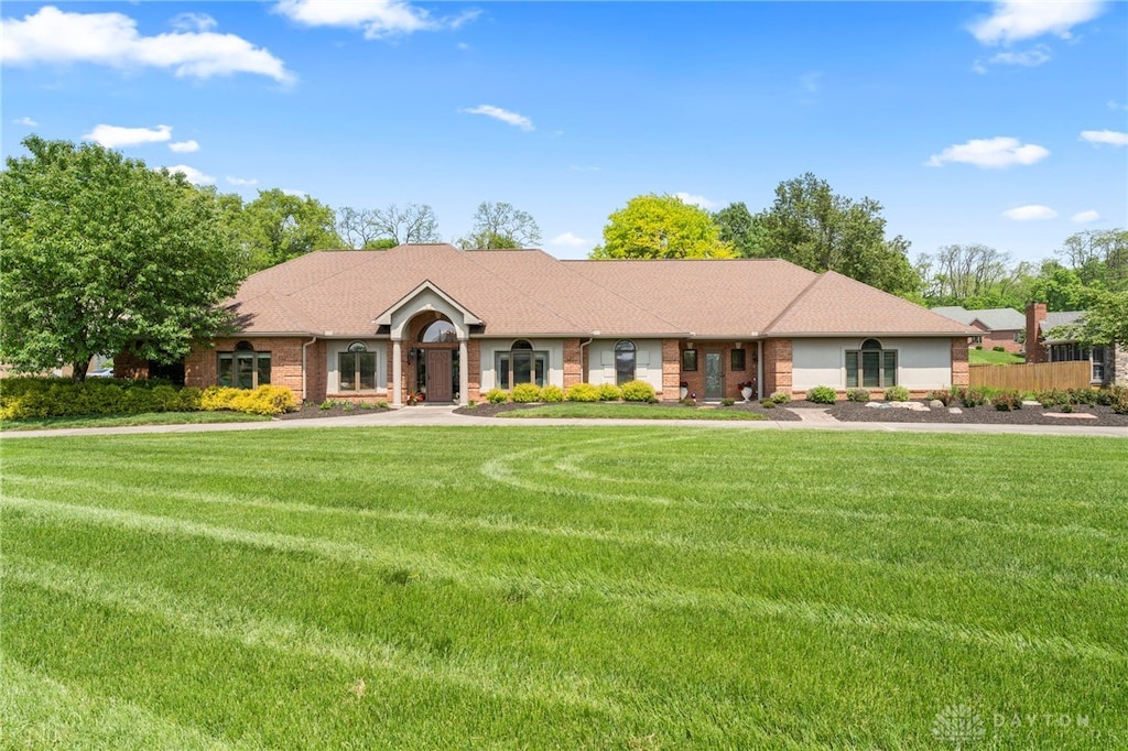 6752 Stillmead Dr, Dayton, OH 45414 - ranch-style house with a front lawn and brick siding