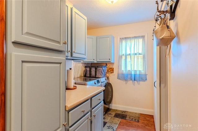 849 Wind Blf, Springboro, OH 45066 - washroom featuring cabinet space, washer and dryer, baseboards, and a textured ceiling