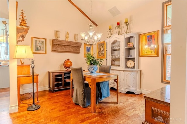849 Wind Blf, Springboro, OH 45066 - dining space featuring a chandelier, wood finished floors, vaulted ceiling, and baseboards