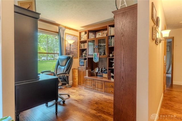 849 Wind Blf, Springboro, OH 45066 - office area with wood finished floors, a textured ceiling, baseboards, and crown molding