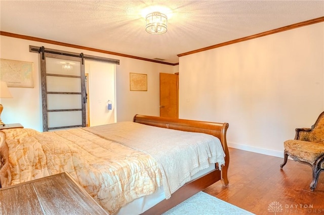 849 Wind Blf, Springboro, OH 45066 - bedroom with wood finished floors, a barn door, ornamental molding, baseboards, and a textured ceiling