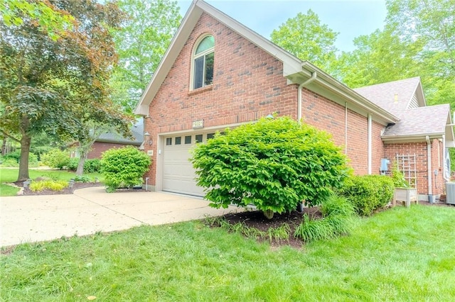 849 Wind Blf, Springboro, OH 45066 - view of side of home with a garage, brick siding, driveway, and a lawn