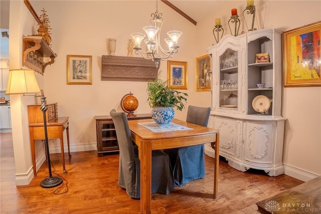 849 Wind Blf, Springboro, OH 45066 - dining room with vaulted ceiling, a chandelier, wood finished floors, and baseboards