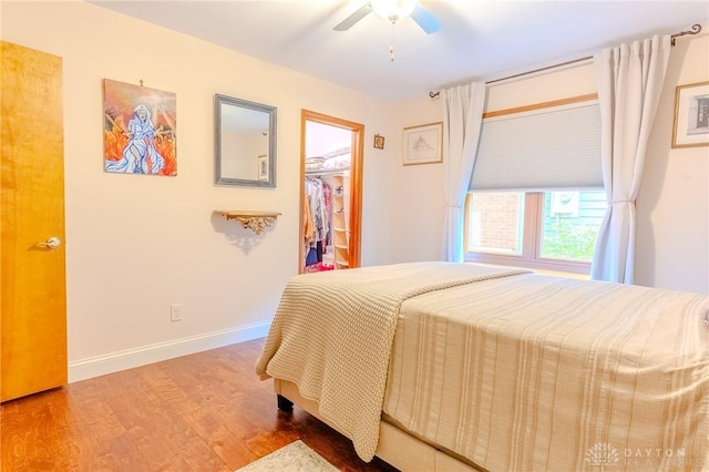 849 Wind Blf, Springboro, OH 45066 - bedroom featuring wood finished floors, baseboards, a spacious closet, ceiling fan, and a closet