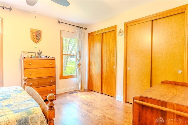 849 Wind Blf, Springboro, OH 45066 - bedroom with multiple closets, light wood finished floors, baseboards, and a ceiling fan