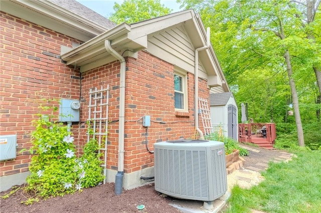 849 Wind Blf, Springboro, OH 45066 - view of side of home with central AC, brick siding, a storage shed, an outdoor structure, and roof with shingles