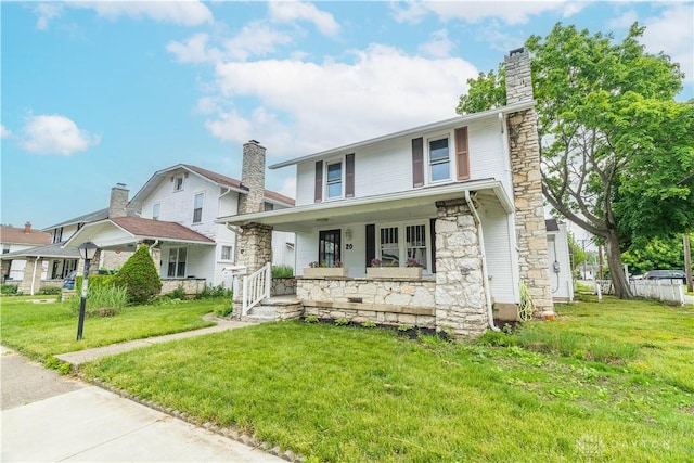 20 N 10th St, Miamisburg, OH 45342 - view of front of home with stone siding, a chimney, covered porch, and a front yard