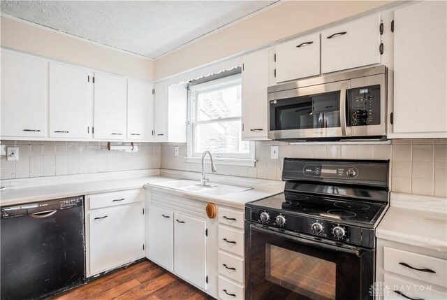 20 N 10th St, Miamisburg, OH 45342 - kitchen featuring black appliances, a sink, dark wood-style floors, light countertops, and a textured ceiling