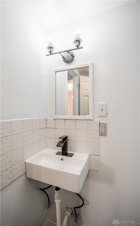 20 N 10th St, Miamisburg, OH 45342 - bathroom with tile walls, a sink, and decorative backsplash