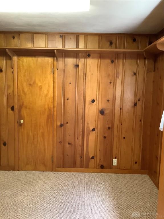 109 Anderson St, New Madison, OH 45346 - interior space featuring carpet flooring and wood walls