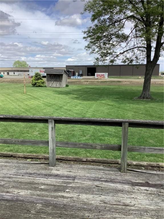 109 Anderson St, New Madison, OH 45346 - view of front facade featuring a storage unit, an outbuilding, and a front lawn