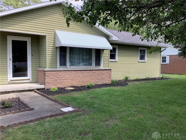 109 Anderson St, New Madison, OH 45346 - view of front of home featuring a front lawn and roof with shingles