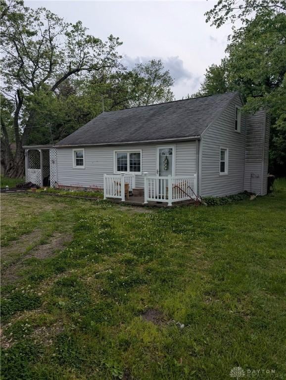 7430 S Kessler Fred Rd, West Milton, OH 45383 - rear view of house featuring a lawn, a deck, roof with shingles, and a chimney