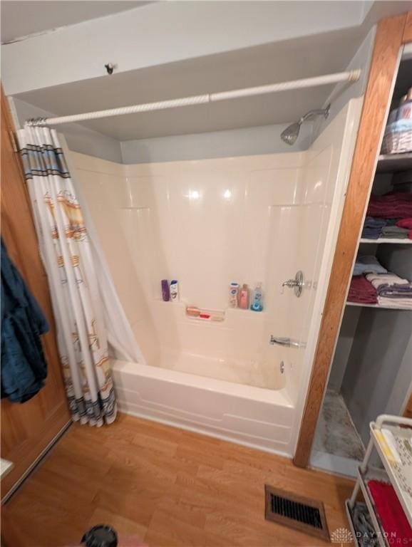 7430 S Kessler Fred Rd, West Milton, OH 45383 - full bathroom with shower / bath combo with shower curtain and wood finished floors