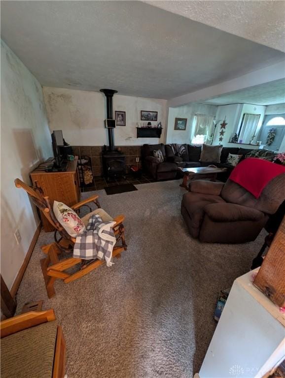 7430 S Kessler Fred Rd, West Milton, OH 45383 - carpeted living room featuring a wood stove and a textured ceiling