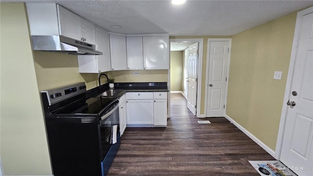 kitchen with electric range, a sink, under cabinet range hood, dark wood-type flooring, and white cabinets