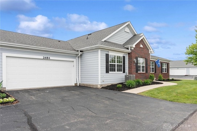 2684 Cedarbrook Way, Beavercreek, OH 45431 - traditional home featuring asphalt driveway, an attached garage, brick siding, and a shingled roof