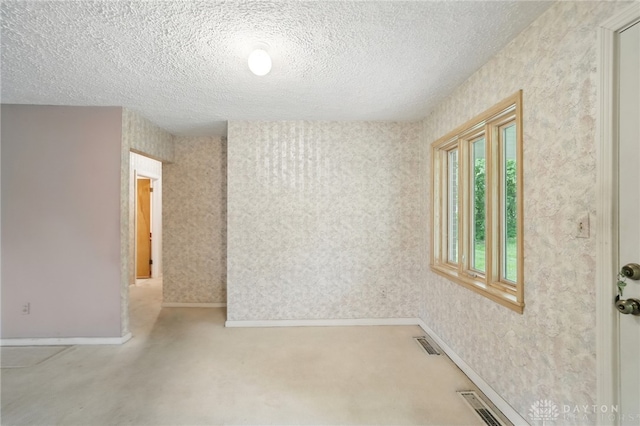 141 W Rahn Rd, Washington Twp, OH 45429 - spare room with a textured ceiling, wallpapered walls, and baseboards