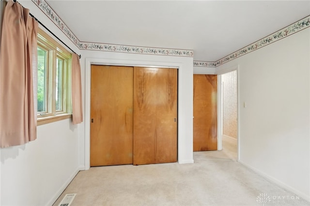 141 W Rahn Rd, Washington Twp, OH 45429 - unfurnished bedroom featuring baseboards, a closet, and carpet