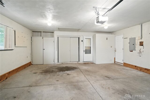 141 W Rahn Rd, Washington Twp, OH 45429 - garage featuring electric panel, a garage door opener, and baseboards