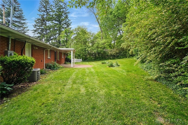 141 W Rahn Rd, Washington Twp, OH 45429 - view of green lawn featuring central air condition unit and a patio
