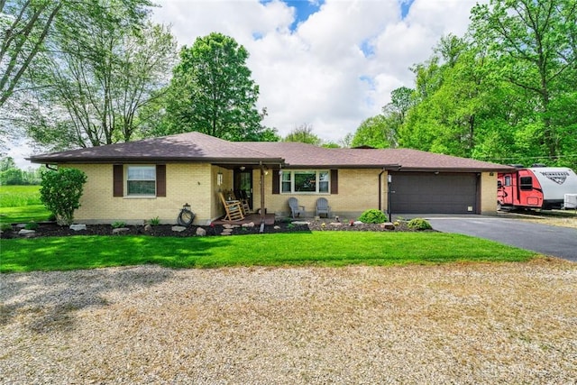 1493 N Sulphur Springs Rd, West Alexandria, OH 45381 - ranch-style house with brick siding, asphalt driveway, a garage, and a front yard