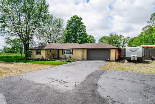 1493 N Sulphur Springs Rd, West Alexandria, OH 45381 - single story home featuring asphalt driveway, a garage, and brick siding