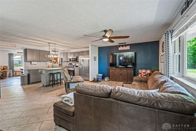 1493 N Sulphur Springs Rd, West Alexandria, OH 45381 - living room featuring a textured ceiling and a ceiling fan