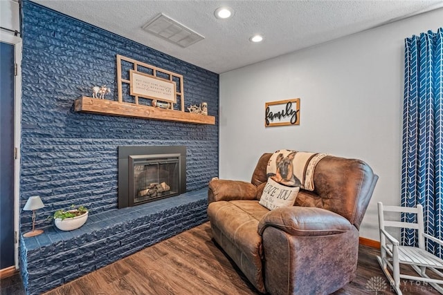 1493 N Sulphur Springs Rd, West Alexandria, OH 45381 - sitting room with wood finished floors, a textured ceiling, a fireplace, recessed lighting, and baseboards