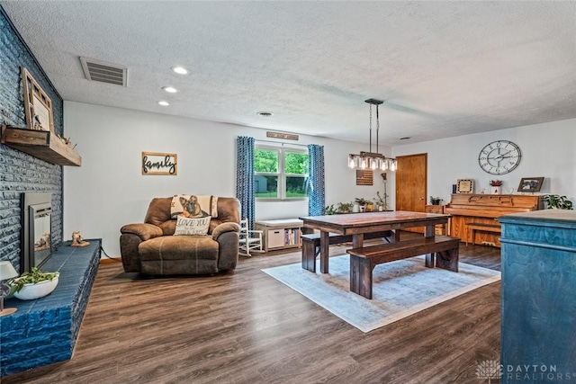 1493 N Sulphur Springs Rd, West Alexandria, OH 45381 - playroom with a textured ceiling, dark wood-type flooring, a brick fireplace, and recessed lighting