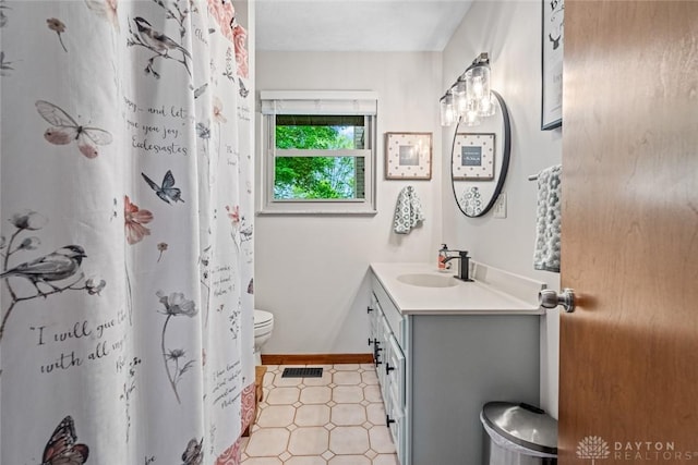 1493 N Sulphur Springs Rd, West Alexandria, OH 45381 - full bath featuring toilet, vanity, tile patterned floors, baseboards, and a shower with shower curtain