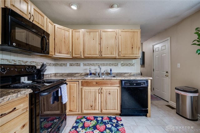 1139 Chalet Dr, New Carlisle, OH 45344 - kitchen with black appliances, a sink, light brown cabinets, and decorative backsplash