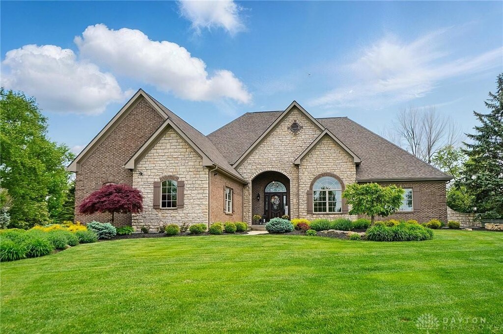 8242 Wilde Ct, Clearcreek Twp, OH 45068 - french provincial home with stone siding and a front yard