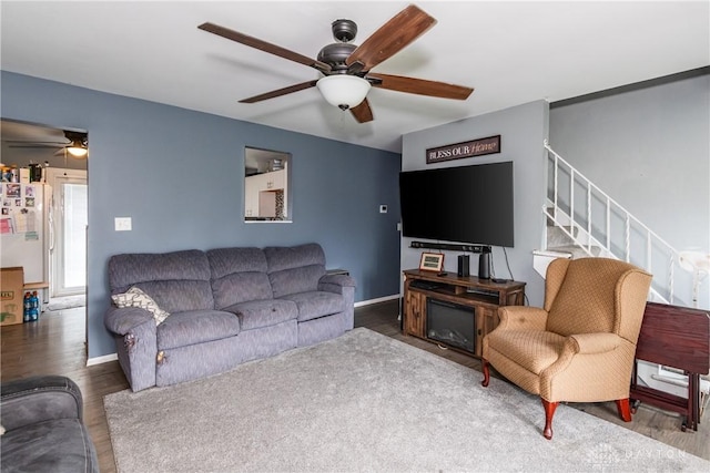 1418 Seminole Dr, Xenia, OH 45385 - living area featuring ceiling fan, wood finished floors, stairs, and baseboards