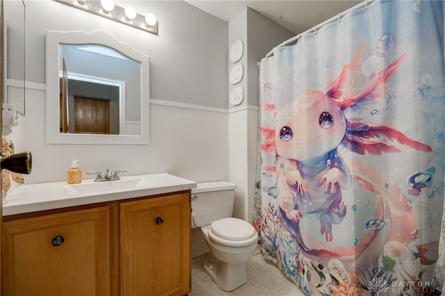 8869 Trowbridge Way, Dayton, OH 45424 - bathroom featuring toilet, a wainscoted wall, vanity, and tile patterned floors