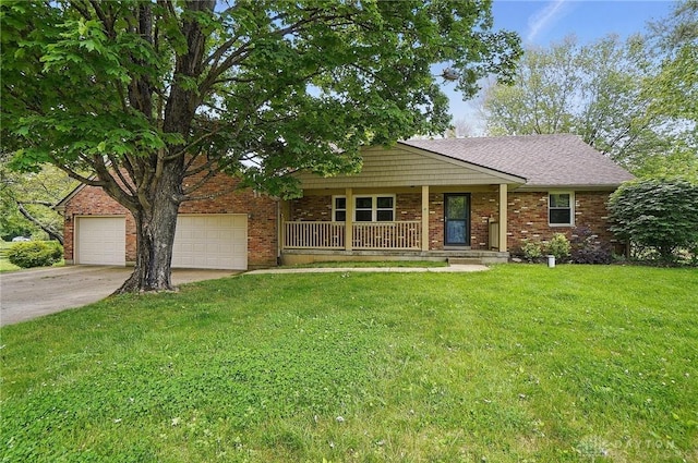 single story home featuring a porch, driveway, a front yard, and brick siding