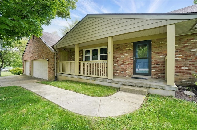 view of front of home with covered porch, brick siding, a garage, and driveway
