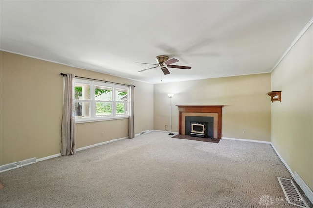 unfurnished living room with ceiling fan, carpet, a fireplace with flush hearth, and baseboards