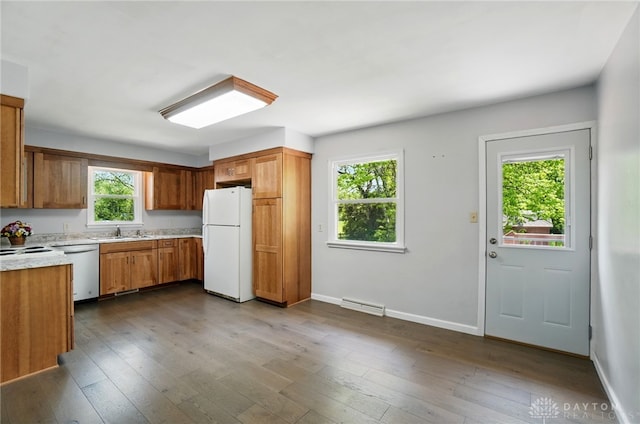 kitchen featuring freestanding refrigerator, a sink, stainless steel dishwasher, light countertops, and brown cabinets