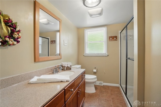 full bath featuring a stall shower, vanity, toilet, and tile patterned flooring