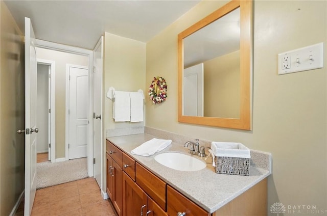 bathroom featuring vanity, tile patterned flooring, and baseboards