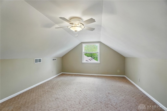 additional living space with carpet, lofted ceiling, baseboards, and ceiling fan