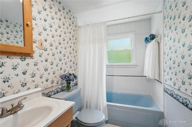 full bathroom with wallpapered walls, toilet, vanity, and shower / tub combo
