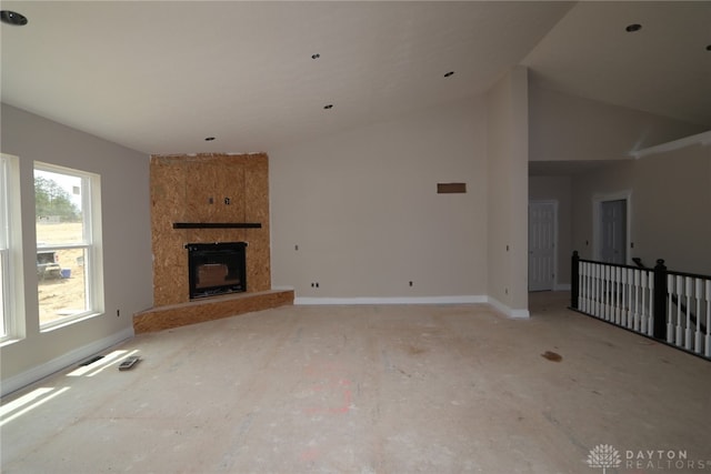 25 Morris St Unit 0013, Springboro, OH 45066 - unfurnished living room featuring baseboards, a fireplace, and a high ceiling